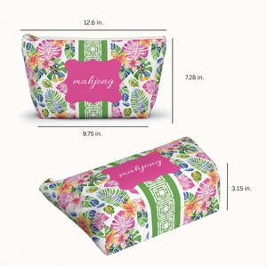 May include: A floral print cosmetic bag with the word "mahjong" in a pink frame. The bag features a zipper closure and measures 12.6 inches wide, 7.28 inches high, and 3.15 inches deep.