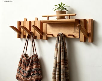 May include: A light brown wooden wall-mounted coat rack featuring multiple angled hooks, a small upper shelf with a railing, and a flat storage surface. A patterned fabric tote bag and a long, fringed, patterned scarf hang from the hooks.