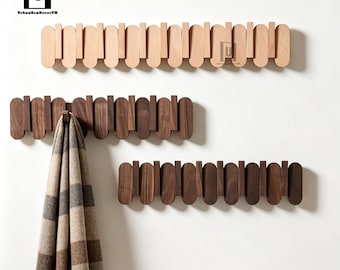 May include: Three horizontal wall-mounted coat racks featuring a series of alternating vertical wooden slats with rounded ends. One rack is light-toned wood, while two are dark-toned wood. A plaid scarf hangs from one hook on the middle rack.
