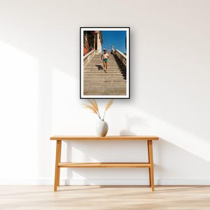 Stair Running Wall Art art print displayed above an entry console table