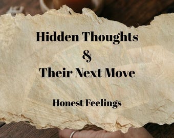 May include: A lit orange candle in a small wooden bowl sits on a dark wooden surface. A piece of parchment paper displays the text "Hidden Thoughts & Their Next Move Honest Feelings". A hand with a ring is visible.