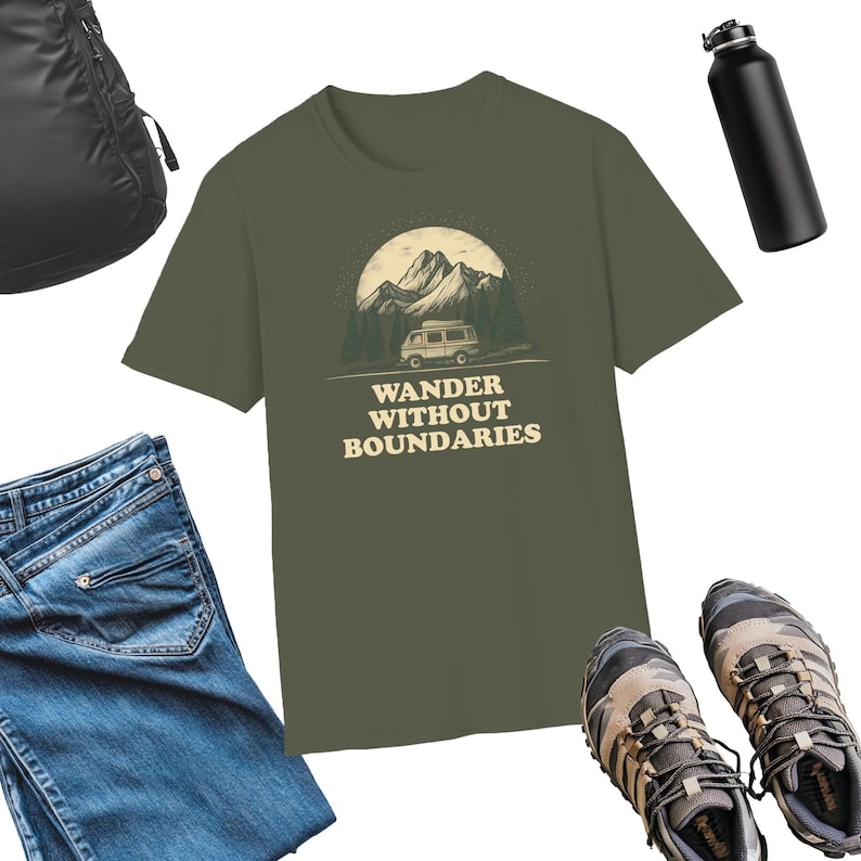 May include: A green t-shirt with a vintage illustration of a van driving through a mountain landscape. The text "WANDER WITHOUT BOUNDARIES" is printed in a cream color below the illustration.