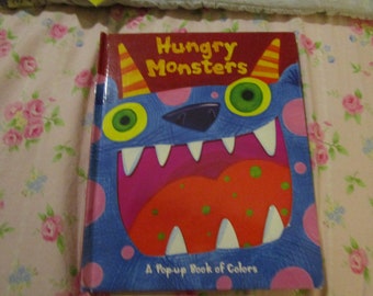 Hungry Monsters A Pop Up Book of Colors Written by Matt Mitter Illustrated by Jo Brown