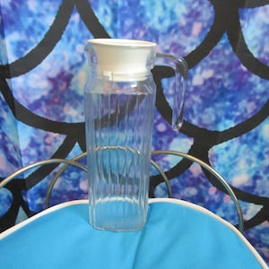 Mid Century Glass Juice Pitcher with Hard Plastic White Top and a glass handle