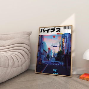 May include: A framed print of a city street scene in Japan. The print features a vibrant sunset sky, a street lined with buildings, and a small white van driving down the street. The Japanese word "バイブス" is printed in black at the top of the print.