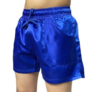 May include: Blue satin shorts with a drawstring waist and a single pocket on the right side.