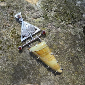 May include: A silver pendant with a leaf design and a brown and yellow agate stone. The pendant is hanging from a silver chain.