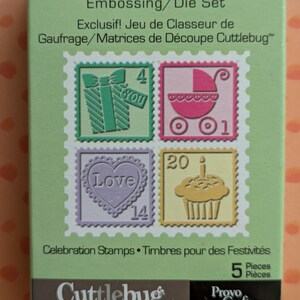 May include: A green box set of Cuttlebug embossing and die cut stamps. The stamps feature gift, baby carriage, heart, and cupcake designs. The box reads "Exclusive! Cuttlebug Embossing/Die Set" and "Celebration Stamps".