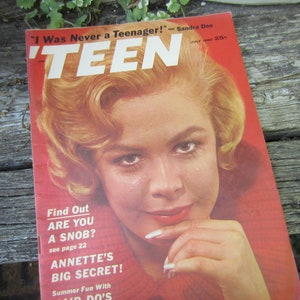 May include: A vintage magazine cover featuring a young woman with blonde hair and a red dress. The magazine is titled "TEEN" and the cover text reads "I Was Never a Teenager!" - Sandra Dee. The magazine is dated July 1960.