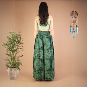 May include: Green wide-leg pants with a mandala print. The pants have an elastic waistband and a flowing silhouette.