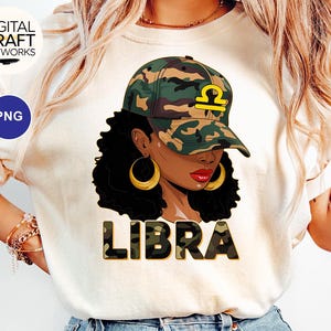 May include: A white t-shirt with a graphic of a Black woman wearing a camouflage hat with the word "LIBRA" in a camouflage font.
