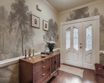May include: An entryway featuring a wooden console table with drawers and a woven panel. The walls are adorned with a mural of a forest scene in shades of gray. Two framed pictures hang above the console.