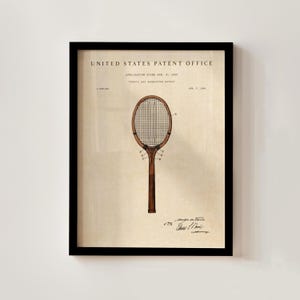 May include: Framed vintage tennis and badminton racket patent print. The print features a detailed illustration of a racket with a wooden frame and stringed net. The text "United States Patent Office" is at the top, with application details and a signature at the bottom.