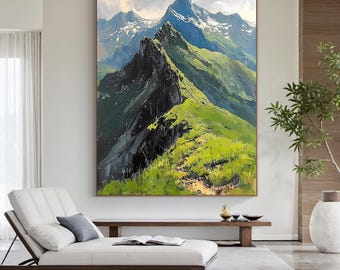 May include: Large framed oil painting of a mountain range. The artwork depicts a vibrant green grassy ridge leading to snow-capped peaks under a cloudy sky. The painting is displayed in a modern living room setting.