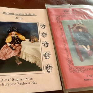May include: Two doll pattern packets. One features a doll named "Jilly" with a fabric fashion hat, the other a 14-inch bean bag doll. The packets are labeled "Barbara Willis Designs."