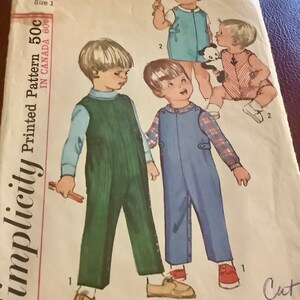 May include: Vintage Simplicity pattern 6157 for toddler size 1. The pattern features illustrations of children in overalls and rompers. The pattern is printed in Canada and includes the price of 50 cents.
