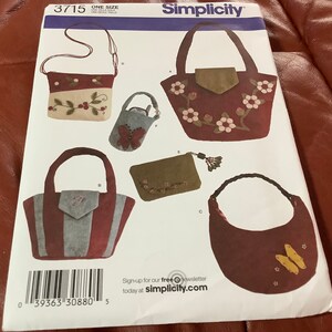 May include: Simplicity sewing pattern featuring various bag designs. The pattern includes a shoulder bag with a berry design, a tote bag with a flap, a small purse with a butterfly, a clutch with a tassel, and a crescent-shaped bag with butterflies.