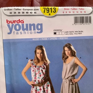 May include: A sewing pattern for a dress from Burda Young Fashion, featuring two dress designs. The pattern includes European and US sizes, with the number 7913 in a yellow circle. The word "easy" is also visible.