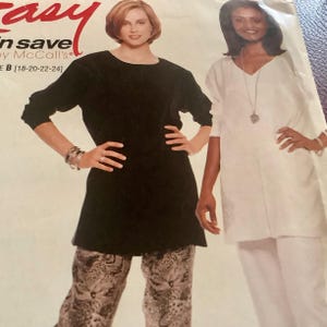 May include: A sewing pattern featuring two women modeling clothing. One woman wears a black tunic and patterned pants. The other wears a white tunic and pants. The pattern is by McCall's.