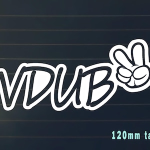 May include: White vinyl sticker with the text "VDUB" in black lettering and a white peace sign with black outline. The sticker is 120mm tall.