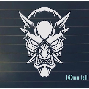 May include: White vinyl decal of a Japanese Oni mask with horns, fangs, and a fierce expression. The decal is 160mm tall.
