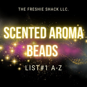 May include: A black background with a galaxy of gold glitter and a pink nebula. The text "THE FRESHIE SHACK LLC." is at the top of the image. The text "SCENTED AROMA BEADS LIST #1 A-Z" is in the center of the image.