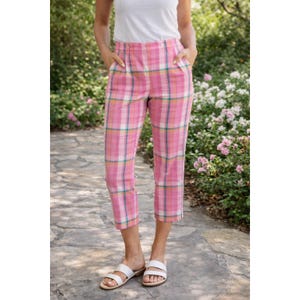 May include: Pink plaid capri pants with a white and yellow grid pattern. The pants have pockets and are worn with white sandals. The capri pants are a cropped length.