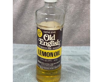 Botella de vidrio de aceite de limón Old English para pulir muebles, marca Boyle-Midway, 50% llena.