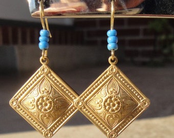 Gold medallion dangle earrings with turquoise colored beads