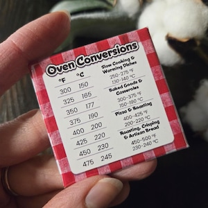 May include: A small, rectangular oven conversion chart with a red and white checkered pattern. The chart lists Fahrenheit and Celsius temperature conversions for various cooking methods, including baking and roasting.
