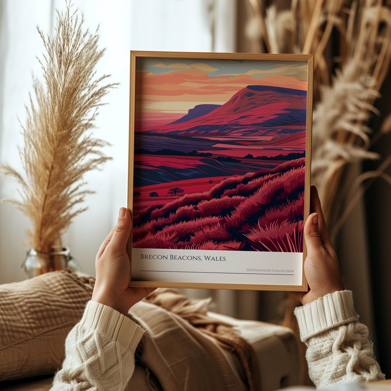 May include: A framed print of a colorful landscape with a mountain range in the background. The print is titled "Brecon Beacons, Wales" and is part of a "Destinations Collection".