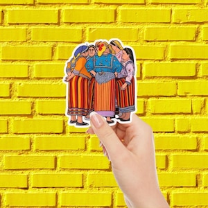 May include: A sticker featuring a group of women in traditional clothing, with colorful striped skirts and detailed blouses. The women are gathered closely together. The sticker is held against a yellow brick wall.