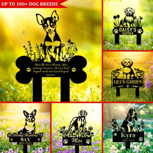 May include: Black metal garden stakes featuring dog silhouettes and names. The stakes include text such as "Daisy's Garden", "Lily's Garden", and "In Loving Memory Of Max". The top banner reads "UP TO 100+ DOG BREEDS".
