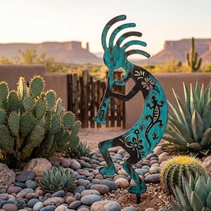 May include: A turquoise and black metal Kokopelli garden sculpture. The figure is playing a flute and decorated with floral and lizard designs. The sculpture is placed in a garden with cacti and rocks, with a desert landscape in the background.