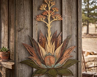 May include: A metal wall art piece shaped like an agave plant with a tall, golden-yellow flowering stalk. The base features layered, pointed leaves in shades of copper, bronze, and muted olive green, with a textured, weathered metallic finish.
