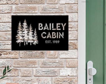 May include: Black metal sign with a white silhouette of pine trees and the text "Bailey Cabin Est. 1989".