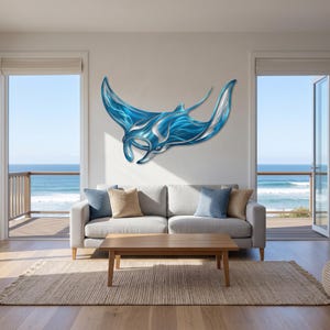 May include: A large, wall-mounted metal sculpture of a manta ray. The piece features a polished, reflective surface with vibrant blue and silver tones, showcasing fluid, sweeping curves that mimic the graceful swimming motion of the sea creature.