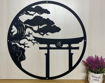 May include: Black metal wall art featuring a stylized Japanese pine tree and a torii gate with the kanji character for "way" or "path" inscribed on the top. The design is circular and has a rustic wood background.