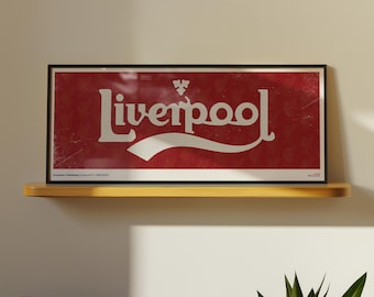May include: A rectangular framed print featuring a red background with a subtle repeating pattern and the white text Liverpool in a stylised font. The design includes a small white emblem above the text and a white swoosh graphic below.