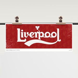 May include: A rectangular red banner featuring the white text Liverpool in a stylised font with a small white emblem above the letters. The background has a subtle repeating pattern and a distressed texture. The banner is held by two metal clips.