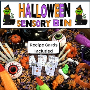 May include: A Halloween Sensory Bin with the text "Halloween Sensory Bin" and "Recipe Cards Included". The bin contains various Halloween-themed toys, including pumpkins, eyeballs, bones, and witch fingers. The bin is filled with a mix of colorful grains.