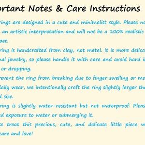 May include: A light yellow informational card with black text titled Important Notes & Care Instructions. It lists five numbered points in blue text regarding the handling, material, sizing, and water resistance of handcrafted clay rings.