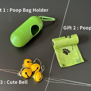 May include: Three gifts for a dog owner: a green poop bag holder, a green poop bag with paw prints, and a set of four yellow jingle bells.