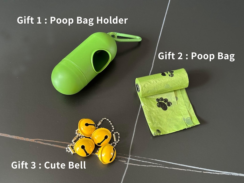 May include: Three gifts for a dog owner: a green poop bag holder, a green poop bag with paw prints, and a set of four yellow jingle bells.