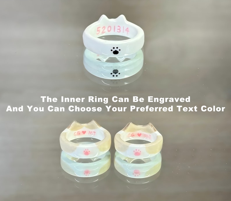 K&ouml;nnte beinhalten: Zwei wei&szlig;e katzenf&ouml;rmige Ringe mit Pfotenabdr&uuml;cken. Der innere Ring kann mit Text in Pink graviert werden. Der Text auf dem oberen Ring lautet "5201314".