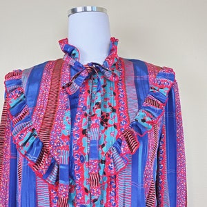 1980er Vintage blaue und rote Rüschenbluse mit abstraktem Druck / 80er Jahre Seide High Neck Prairie Button Up Shirt / Mittel Groß Bild 5