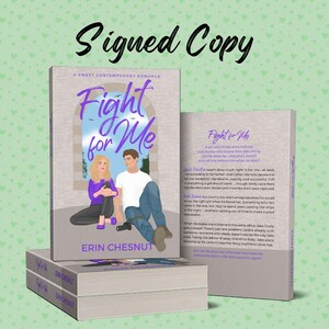 May include: A stack of paperback books with a purple cover and the title "Fight for Me" in white text. The cover features an illustration of a young couple sitting on a bench in front of a window. The back cover features a description of the book.