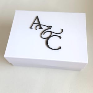 May include: A rustic wooden sign with the text "Welcome to our home" in white lettering. The sign features a distressed finish and a simple, inviting design, perfect for entryway decor.