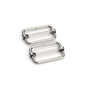 May include: Two silver metal slider buckles. The buckles are rectangular with a smooth, polished finish.