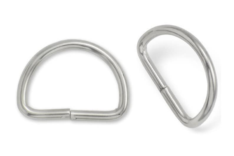 May include: Two silver metal D-rings, each with a smooth, rounded surface. The rings are open and ready to be attached to a project.